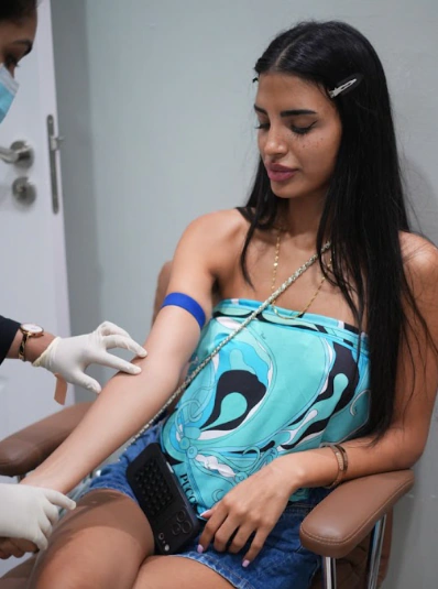 IV Drip Therapy in Dubai Woman holding an IV drip bag for wellness therapy at Tinkermoon Clinic Dubai
