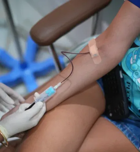 Close-up of IV drip catheter insertion with tubing during therapy at Tinkermoon Clinic Dubai