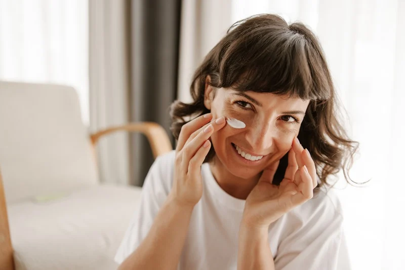 Applying sunscreen to facial skin