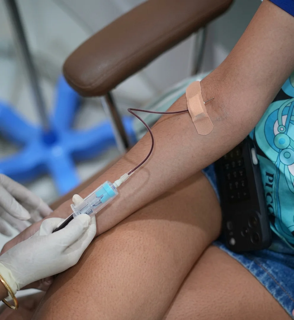 Healthcare professional preparing a patient's arm for IV drip therapy at Tinkermoon Clinic Dubai